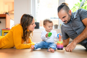 Adorable Infant Baby Playing At Home Living Room with parents