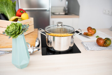 Pot with spaghetti in a kitchen