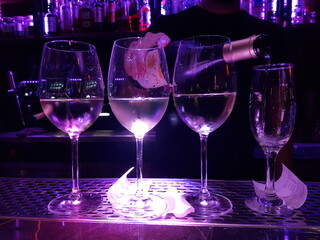 bar wine glasses barman pouring wine from the bottle for