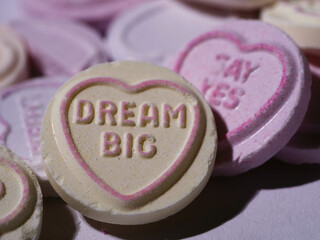 Obraz na płótnie Canvas Dream big message wrote on love heart candy on pink background 