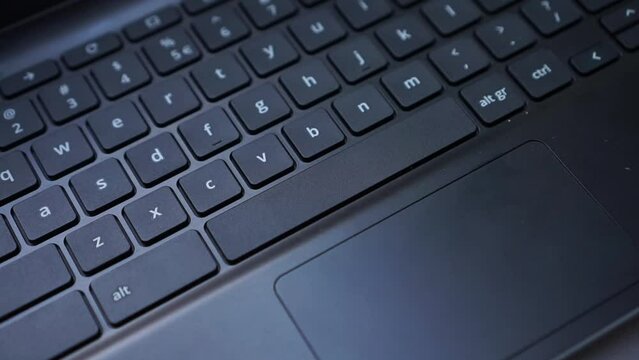 An index finger Pressing the space key on the laptop keyboard