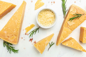 Parmesan cheese, Hard cheese, rosemary on a light background. Long banner format. top view