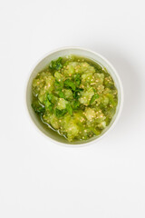 Physalis or tomatillo sauce in ceramic bowl isolated on white background top view