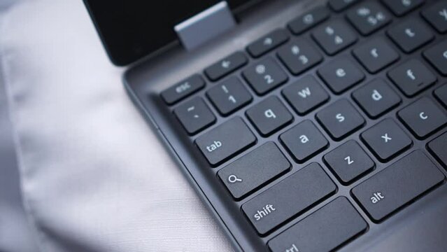 An index finger press the search key on the laptop or notebook keyboard.