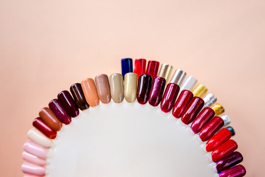 Nail polish samples in different bright colors. Colorful nail lacquer manicure swatches. nail art wheel palette.Top view colorful shiny glitter nails polish palette set for manicure