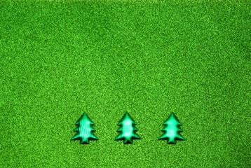 Christmas tree toy Christmas tree made of foil on a green background