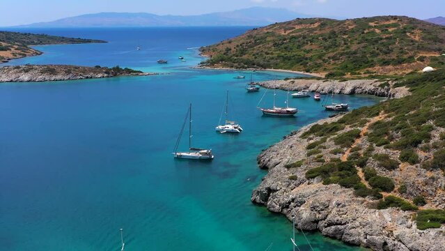 Aerial mediterranean sea landscape with sailing boat, yachts, turquoise clear water and bay coastline