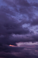 Dramatic sunrise, sunset pink blue violet storm sky with clouds background texture	