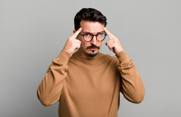 looking concentrated and thinking hard on an idea, imagining a solution to a challenge or problem