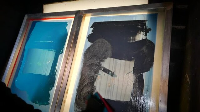 Cleaning plastisol ink from screen printing screens using chemicals and a scrubbing pad. 