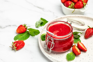 Jar of strawberry jam on white background. Homemade strawberry marmelade and fruits. Long banner format