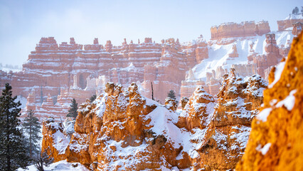 bryce canyon national park in winter, unique rock formations in utah covered in snow, orange rocks...