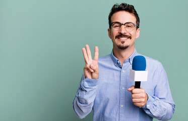 adult man smiling and looking friendly, showing number three with a microphone. presenter or...
