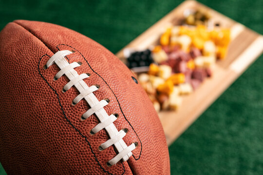 Sports: Football With Party Cheese Board In Background