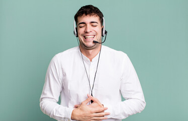 adult man laughing out loud at some hilarious joke with headset. telemarketer operator concept