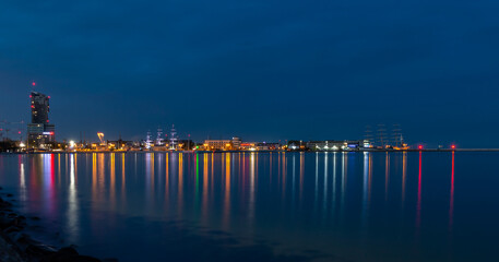 Gdynia port at night. Illuminated wharf in Gdynia. The lights are reflected in the sea