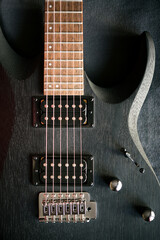 Fototapeta premium close up black electric guitar on black background concept