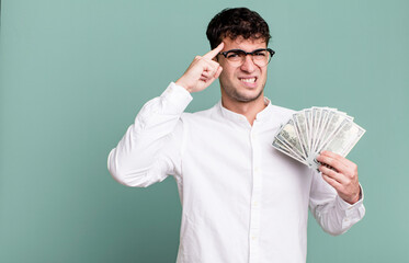 adult man feeling confused and puzzled, showing you are insane. dollar banknotes concept