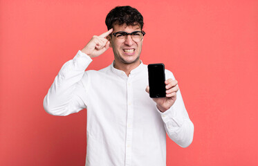 adult man feeling confused and puzzled, showing you are insane and showing his smartphone screen
