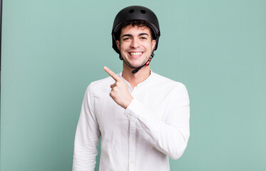 adult man looking excited and surprised pointing to the side. city motorbike rider concept