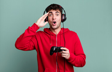 adult man looking happy, astonished and surprised with headset and a controller. gamer concept