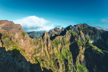 Mountain landscape of Pico Ruivo photographed from a viewing platform with very steep cliffs in the...