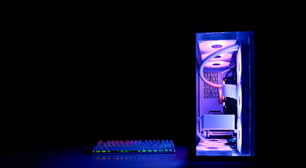 Gaming PC with rainbow LED light. Modern liquid cooled gaming computer. Powerful PC in a glass...