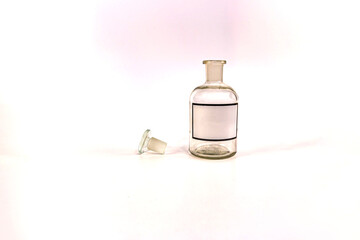 Transparent medical jar with a glass stopper on a white background