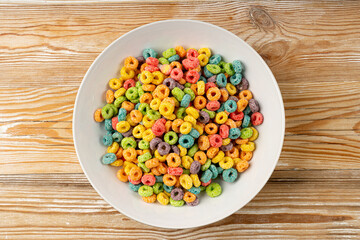 Colorful Breakfast Rings Pile, Fruit Loops, Fruity Cereal Rings, Colorful Corn Cereals on Wood Background