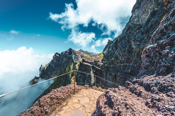 Sportive hiker with backpack walking along super scenic hike trail to Pico do Ariero in the...