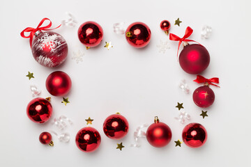 Christmas ball toys and confetti on white background, top view