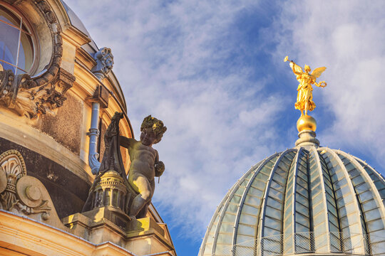 Cityscape - view of the glass dome of the main building of the Dresden Academy of Fine Arts with a sculpture of the goddess Pheme, Dresden, Germany