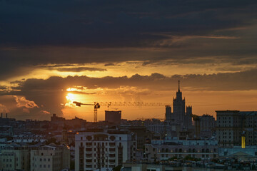 Naklejka premium July 10, 2021. Moscow Russia. Dawn over the Russian capital and a view of the Stalin high-rise on Kotelnicheskaya embankment in the early summer morning.