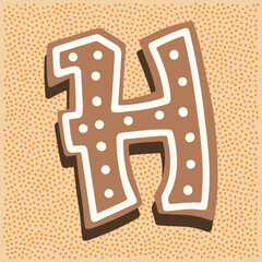 Christmas gingerbread in the shape of a letter H with white icing doodle