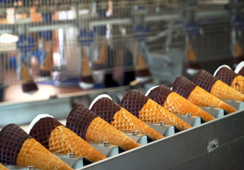 Ice cream cones on conveyor. Ice cream factory.