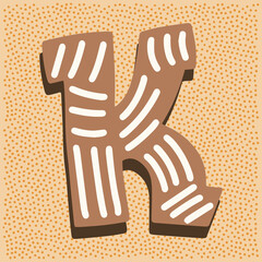 Christmas gingerbread in the shape of a letter K with white icing doodle