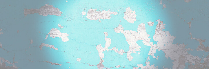 Peeling paint on the wall. Panorama of a concrete wall with old cracked flaking paint. Weathered rough painted surface with patterns of cracks and peeling. Wide panoramic grungy texture for background