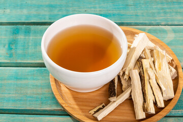 Quassia Amara - Beverage Stems Of Quassia Medicinal plant; On Wood Background