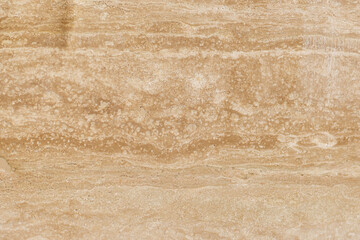 Marble textured background of sand color with light patterns. Marble tiles of sand color with white patterns and spots.