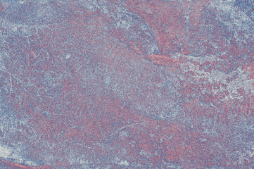 Textured stone background of purple color with real blue patterns and spots. Stone wall in purple and blue tones.
