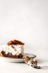 One bite of chocolate cream pie on a fork