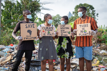 African youth protesting against pollution holding signs written:there's no planet b.