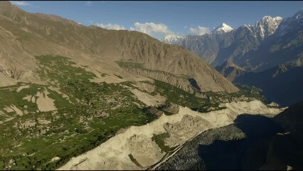 Aerial pan trough hopper glacier during sunrise (golden hour), Pakistan