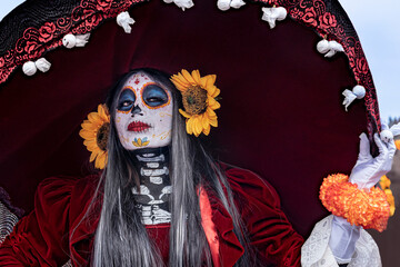 Beautiful woman using a huge red sombrero in Mexico
Fancy red costume used for the Day of the Dead in Mexico
