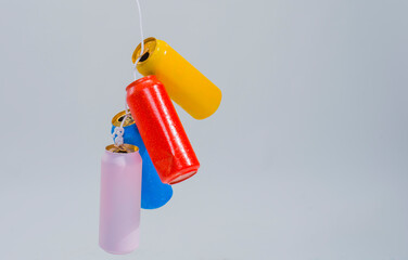 4 multi-colored tin cans on a rope on a white background isolated