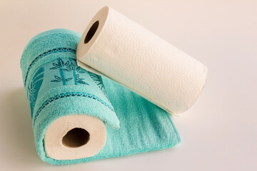 Clean face cotton towel in blue color with paper towel on white background