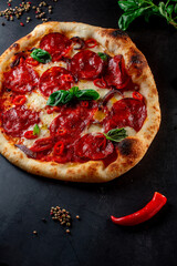 pizza with salami and tomatoes