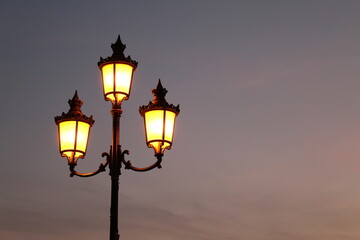 Fototapeta na wymiar Beautiful vintage style street lamp at sunset