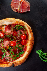 pizza with salami and tomatoes
