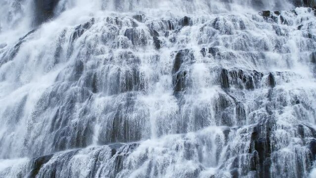 Water stream running through stone boulders, Mountain river, Huge Icelandic waterfall in 4k slow motion